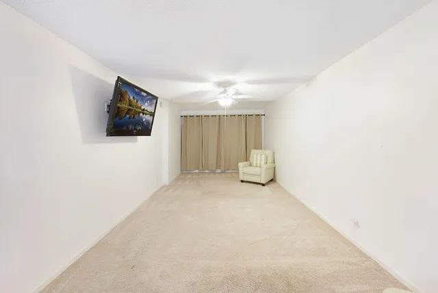 a view of a livingroom with furniture and cabinet in it
