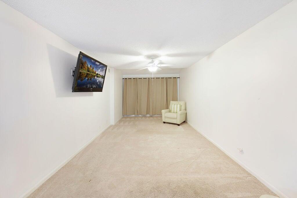 17340 Boca Club Boulevard, Unit 704 Boca Raton, FL 33487 - Photo 11 of 27 a view of a livingroom with furniture and cabinet in it