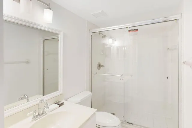 a bathroom with a sink toilet and shower