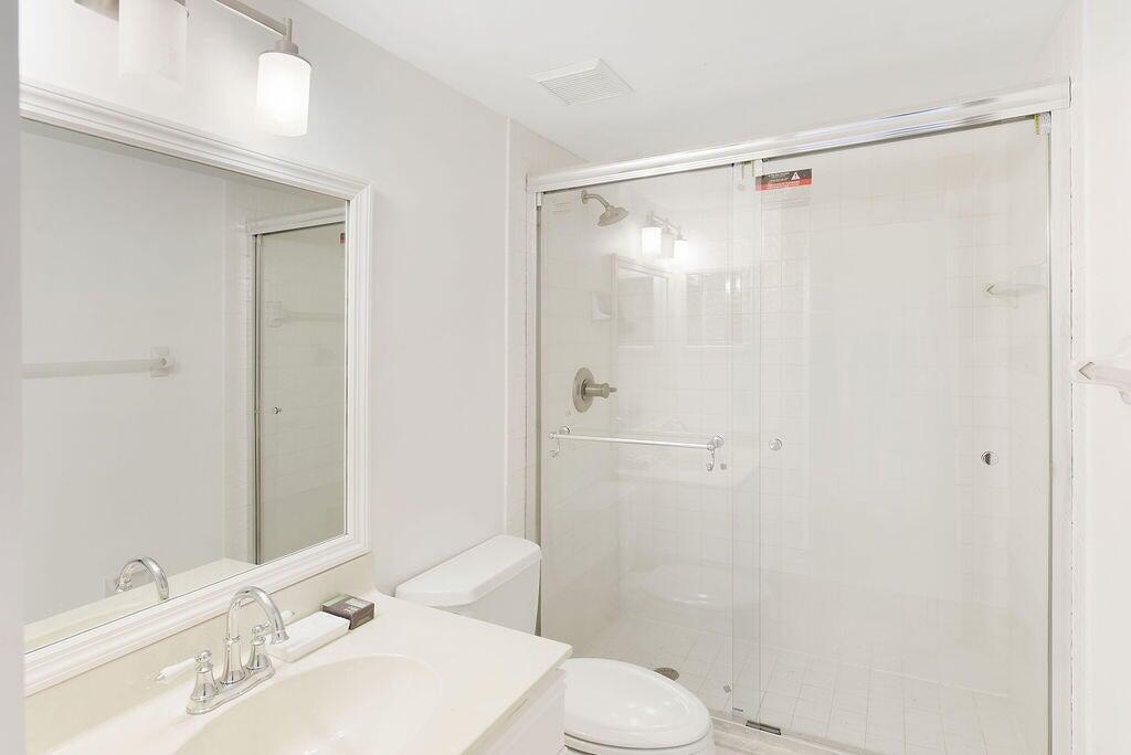 17340 Boca Club Boulevard, Unit 704 Boca Raton, FL 33487 - Photo 14 of 27 a bathroom with a sink toilet and shower