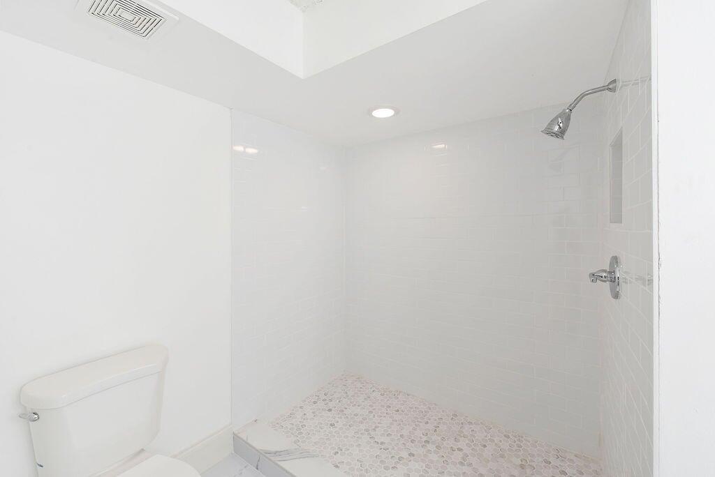 17340 Boca Club Boulevard, Unit 704 Boca Raton, FL 33487 - Photo 15 of 27 a bathroom with a shower