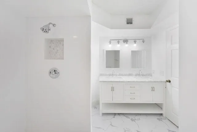 a bathroom with a sink mirror and vanity