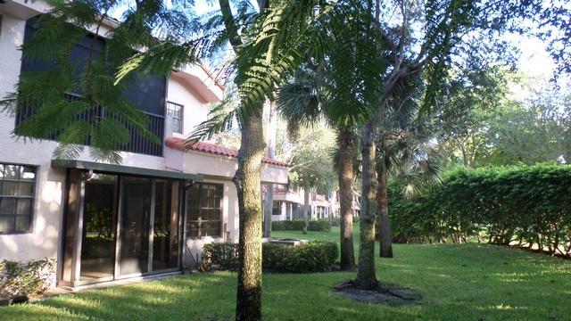 17340 Boca Club Boulevard, Unit 704 Boca Raton, FL 33487 - Photo 20 of 27 front view of a house with a yard