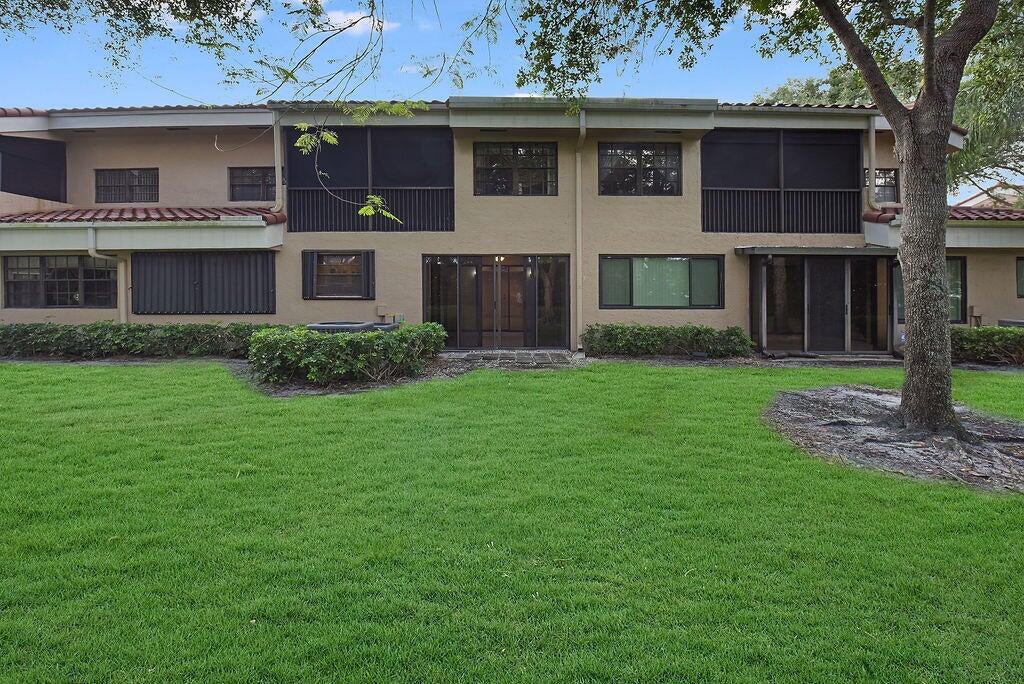 17340 Boca Club Boulevard, Unit 704 Boca Raton, FL 33487 - Photo 22 of 27 a view of a house with a garden