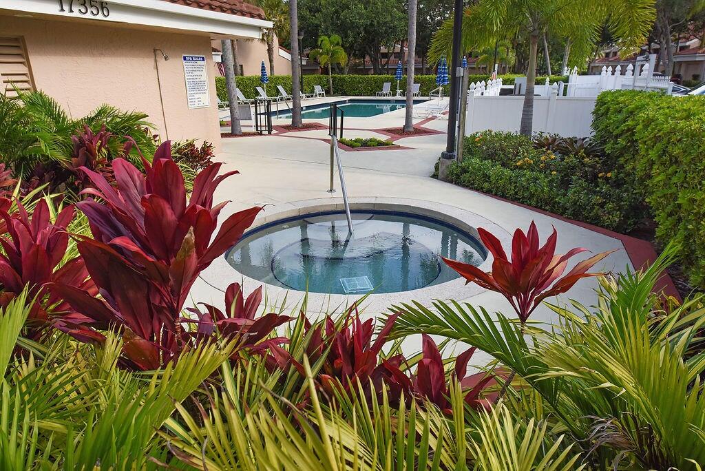 17340 Boca Club Boulevard, Unit 704 Boca Raton, FL 33487 - Photo 25 of 27 a view of swimming pool with outdoor seating and plants