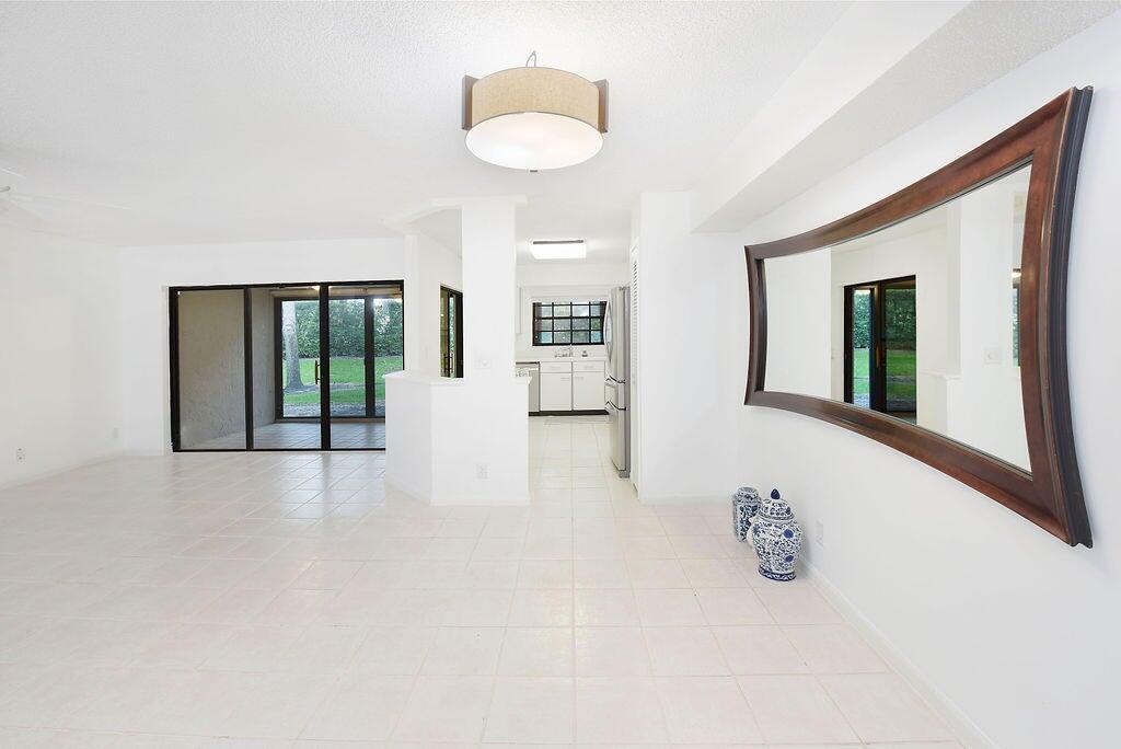 17340 Boca Club Boulevard, Unit 704 Boca Raton, FL 33487 - Photo 7 of 27 a view of an empty room with glass door