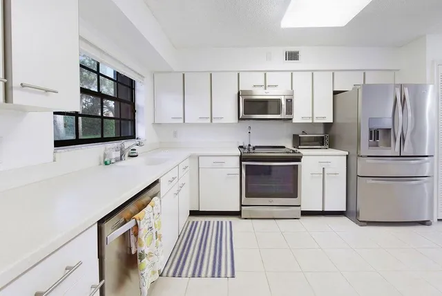 a kitchen with a sink stove and refrigerator