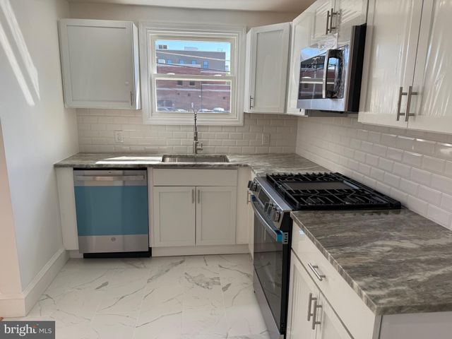 a kitchen with a stove and a refrigerator