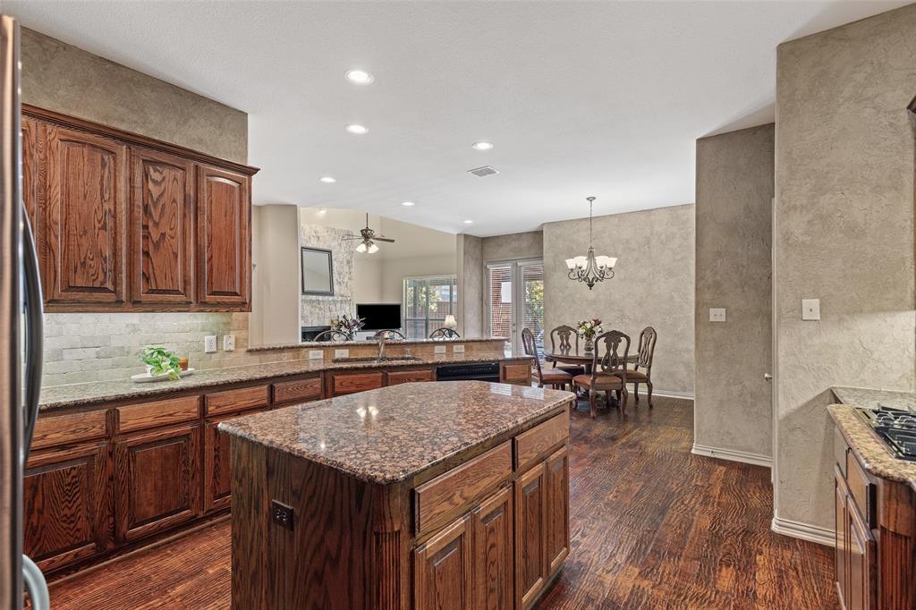 1217 Windmere Way Allen, TX 75013 - Photo 20 of 38 At the heart of the home, the expansive kitchen blends rich cabinetry, granite surfaces, and seamless flow for effortless entertaining and everyday connection.