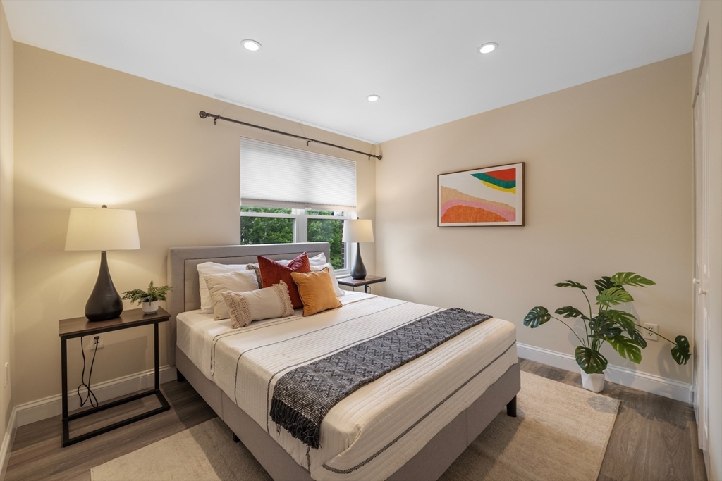 320 Rindge Avenue, Unit 303 Cambridge, MA 02140 - Photo 13 of 28 a bedroom with a bed and a painting