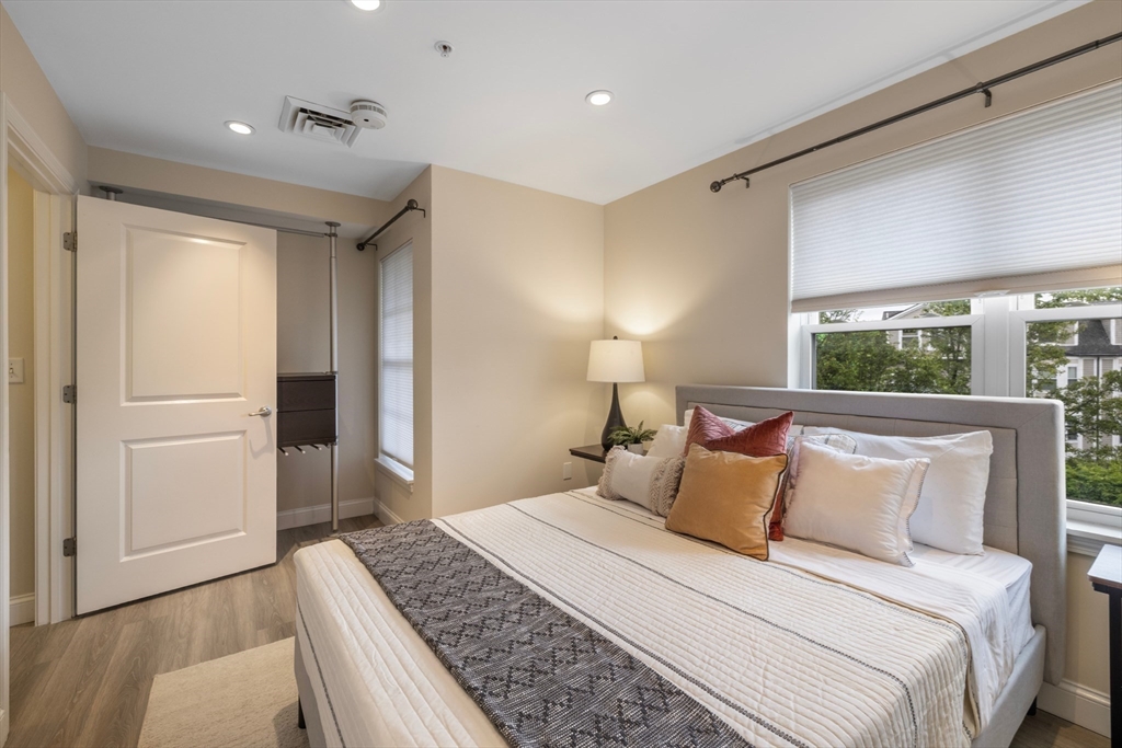 320 Rindge Avenue, Unit 303 Cambridge, MA 02140 - Photo 14 of 28 a bedroom with a large bed and a window