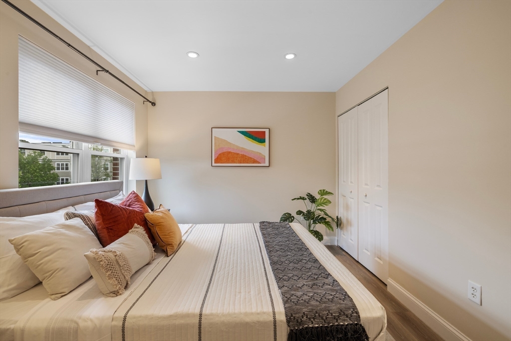 320 Rindge Avenue, Unit 303 Cambridge, MA 02140 - Photo 15 of 28 a bed room with a bed and a large window