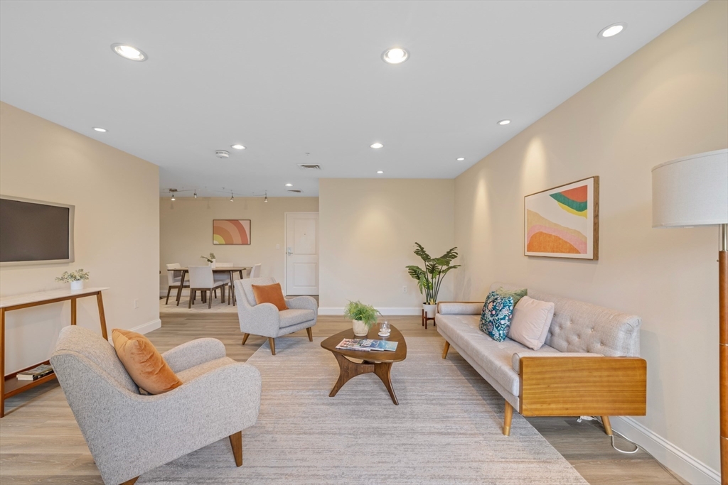 320 Rindge Avenue, Unit 303 Cambridge, MA 02140 - Photo 3 of 28 a living room with furniture and a rug