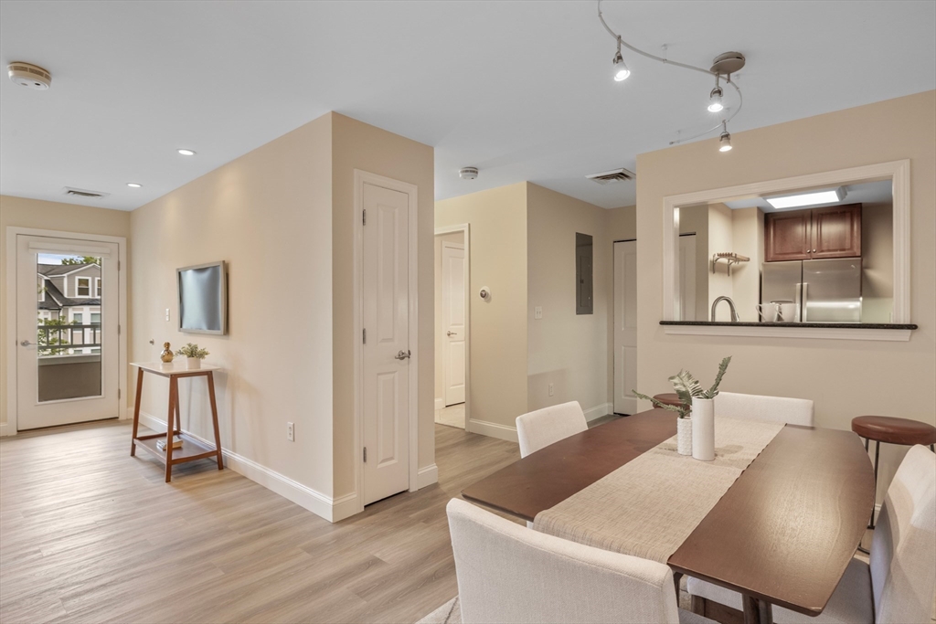 320 Rindge Avenue, Unit 303 Cambridge, MA 02140 - Photo 8 of 28 a view of a a dining room with furniture window and wooden floor