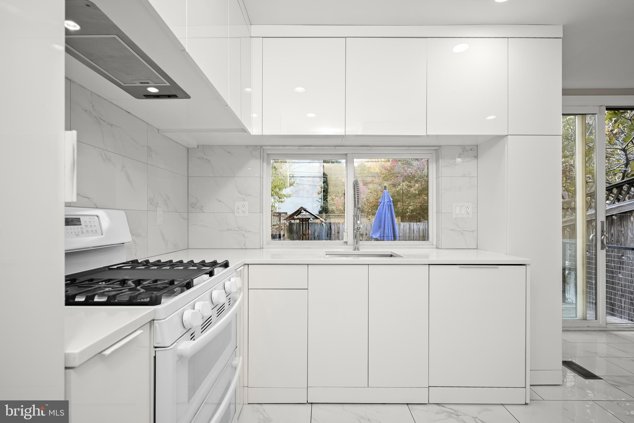 1906 37th Street Northwest Washington, DC 20007 - Photo 11 of 22 a kitchen with white cabinets and appliances