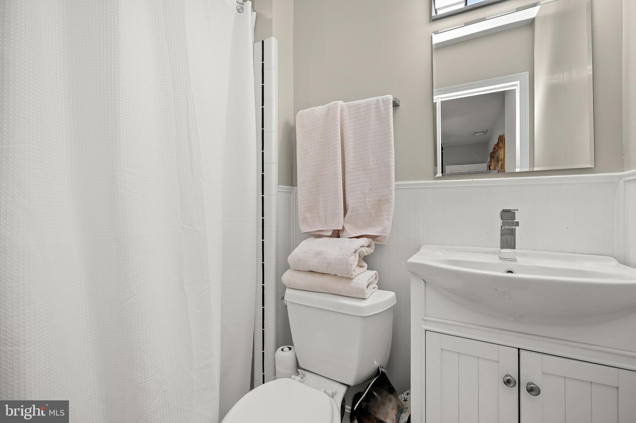 1906 37th Street Northwest Washington, DC 20007 - Photo 15 of 22 a bathroom with a toilet sink and mirror