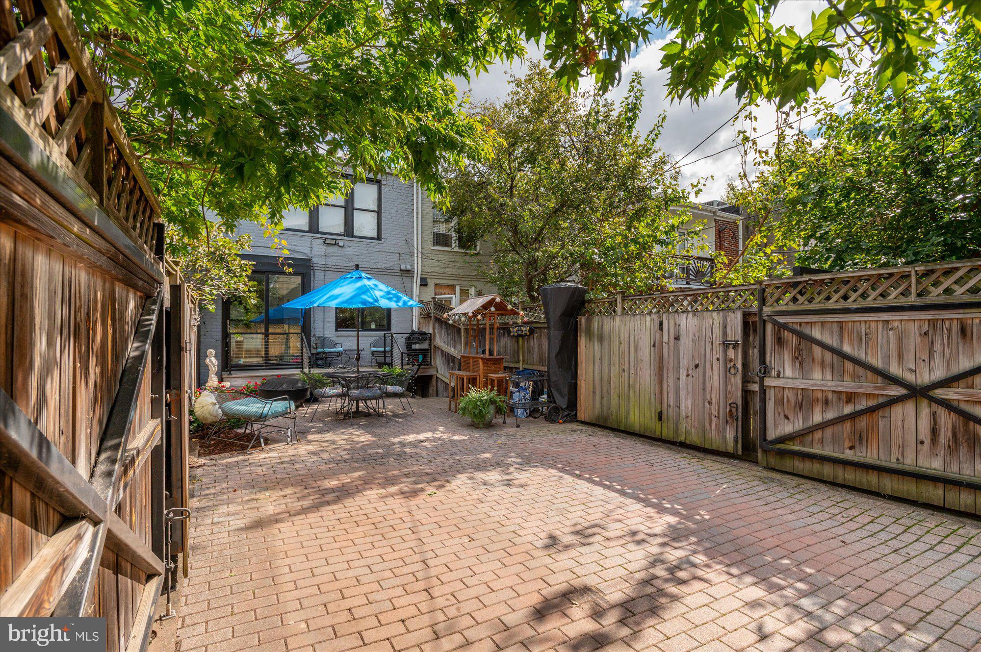 1906 37th Street Northwest Washington, DC 20007 - Photo 4 of 22 a view of a backyard with a small cabin and a chair