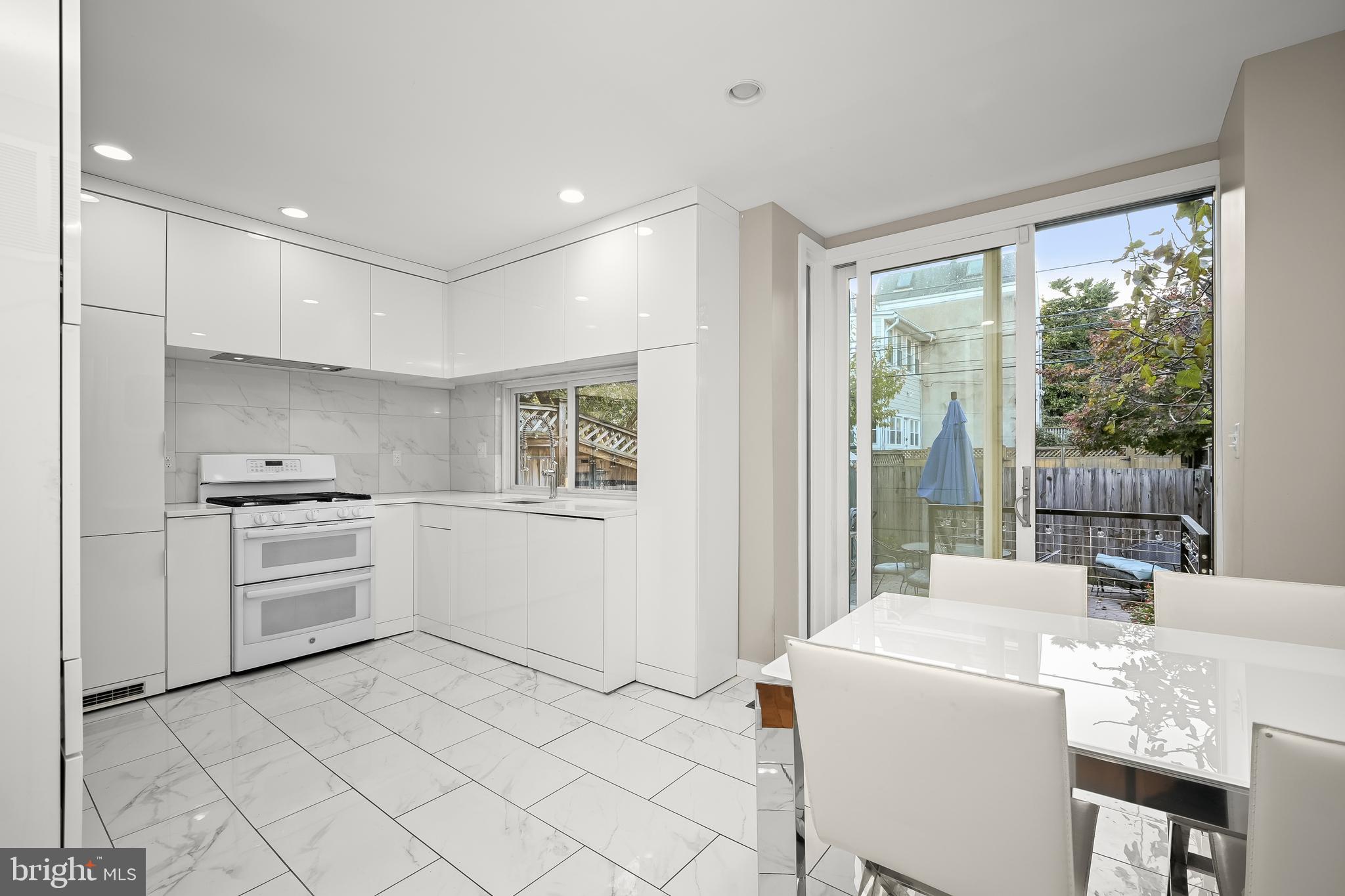 1906 37th Street Northwest Washington, DC 20007 - Photo 8 of 22 a kitchen with a stove a sink and a refrigerator