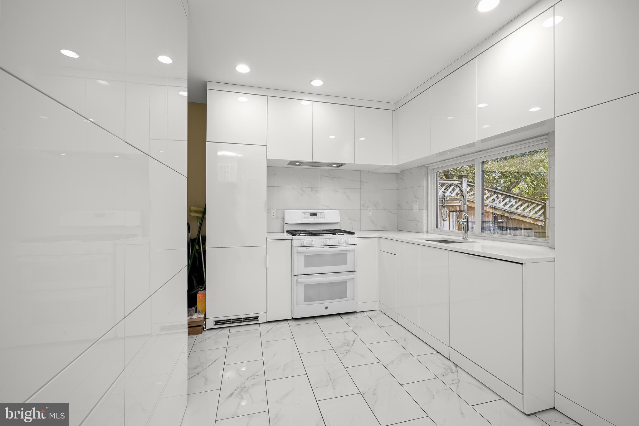 1906 37th Street Northwest Washington, DC 20007 - Photo 9 of 22 a kitchen with white cabinets appliances and a sink