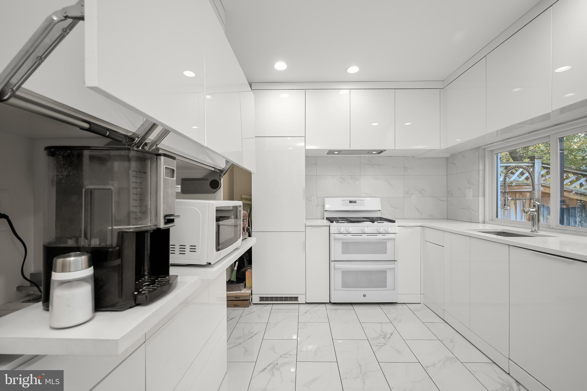 1906 37th Street Northwest Washington, DC 20007 - Photo 10 of 22 a kitchen with stainless steel appliances granite countertop a sink and cabinets