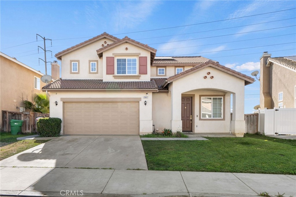 a front view of a house with a yard and garage