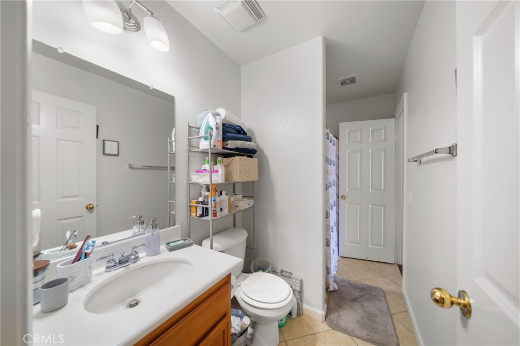 29611 Camino Cristal Menifee, CA 92584 - Photo 13 of 33 a bathroom with a sink toilet and shower