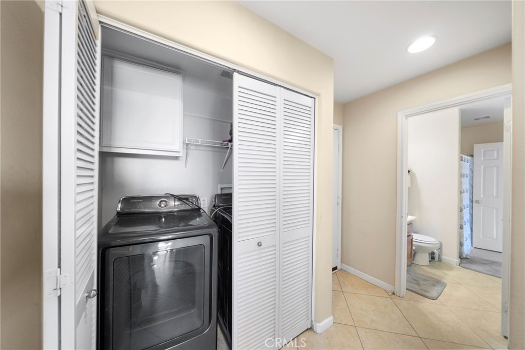 29611 Camino Cristal Menifee, CA 92584 - Photo 15 of 33 a kitchen with a refrigerator and a stove top oven