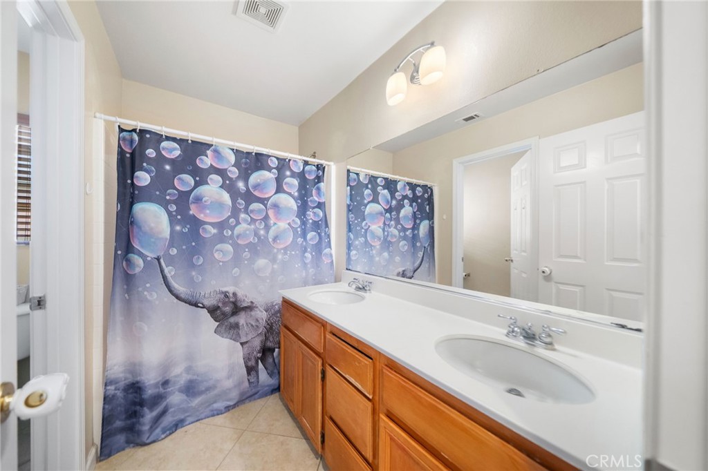 29611 Camino Cristal Menifee, CA 92584 - Photo 20 of 33 a bathroom with a sink and a mirror