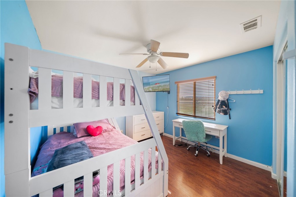 29611 Camino Cristal Menifee, CA 92584 - Photo 21 of 33 a bedroom with a bed and a table