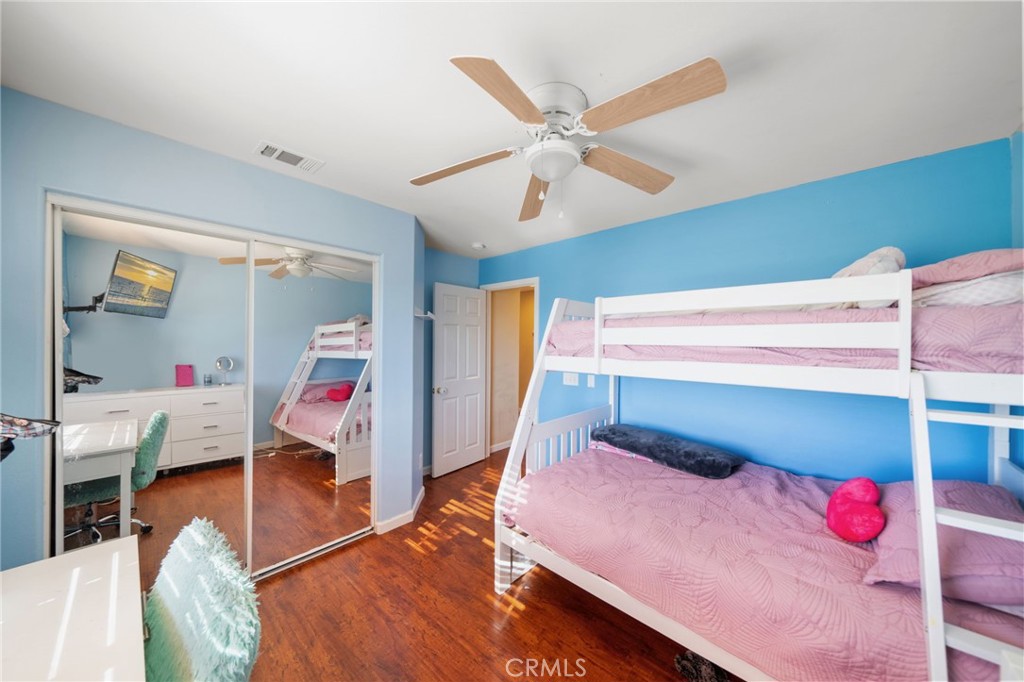 29611 Camino Cristal Menifee, CA 92584 - Photo 22 of 33 a bedroom with a bed and a chandelier