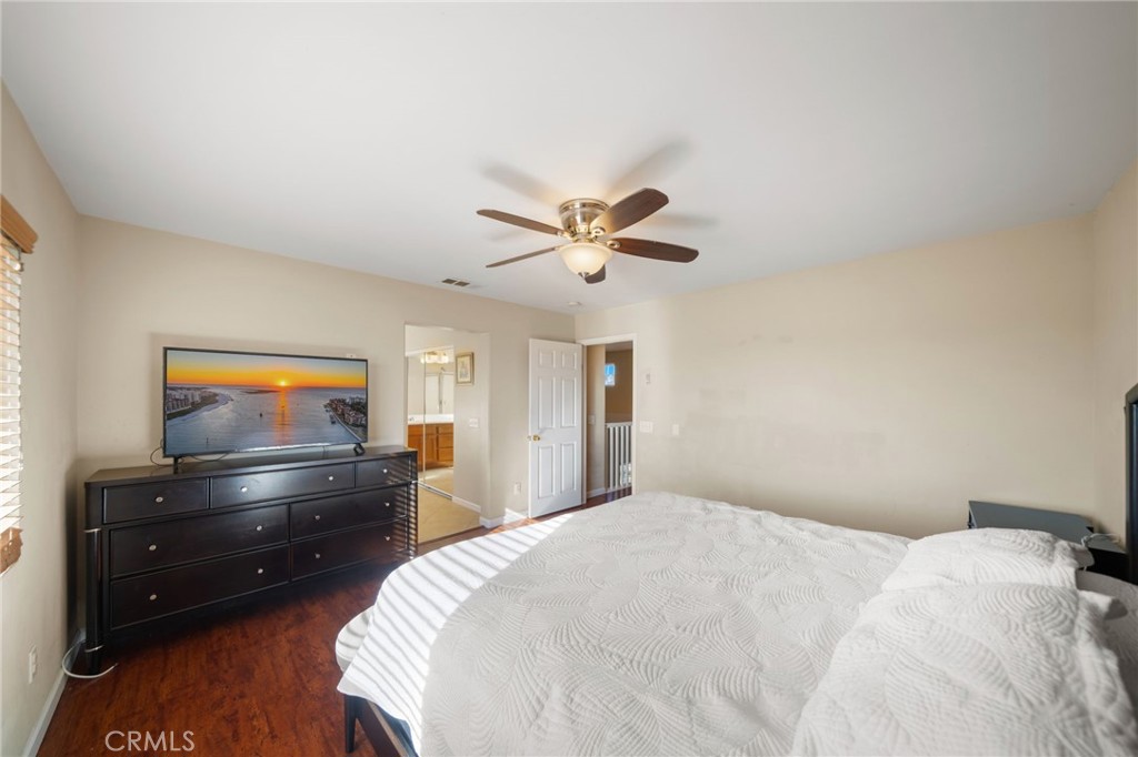 29611 Camino Cristal Menifee, CA 92584 - Photo 24 of 33 a bed room with a bed and a ceiling fan
