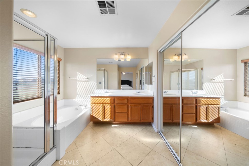 29611 Camino Cristal Menifee, CA 92584 - Photo 25 of 33 a large spacious bathroom with a large tub and shower
