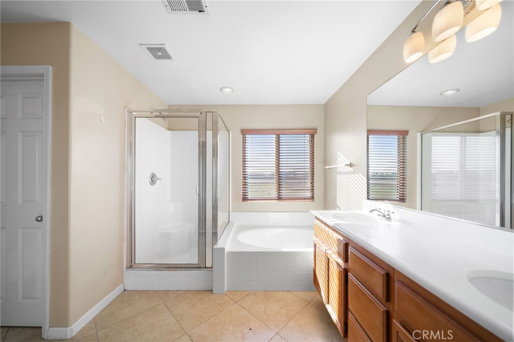 29611 Camino Cristal Menifee, CA 92584 - Photo 26 of 33 a large spacious bathroom with a large tub shower and sink