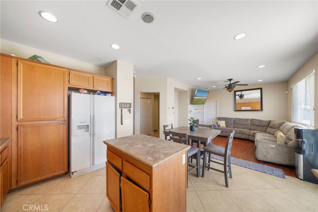 29611 Camino Cristal Menifee, CA 92584 - Photo 6 of 33 a living room with stainless steel appliances granite countertop furniture and a refrigerator