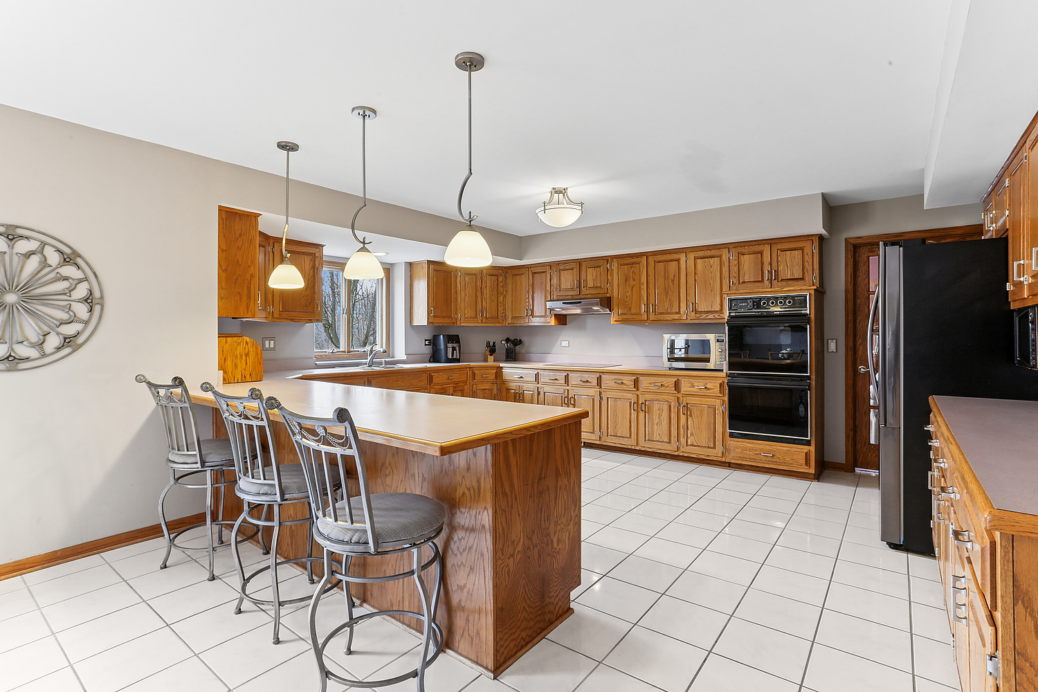 13629 South Kickapoo Trail Homer Glen, IL 60491 - Photo 19 of 28 a kitchen with stainless steel appliances granite countertop a sink a stove and a refrigerator