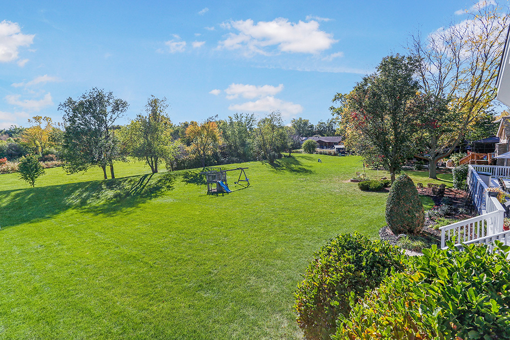 13629 South Kickapoo Trail Homer Glen, IL 60491 - Photo 2 of 28 a view of a garden with a building in the background