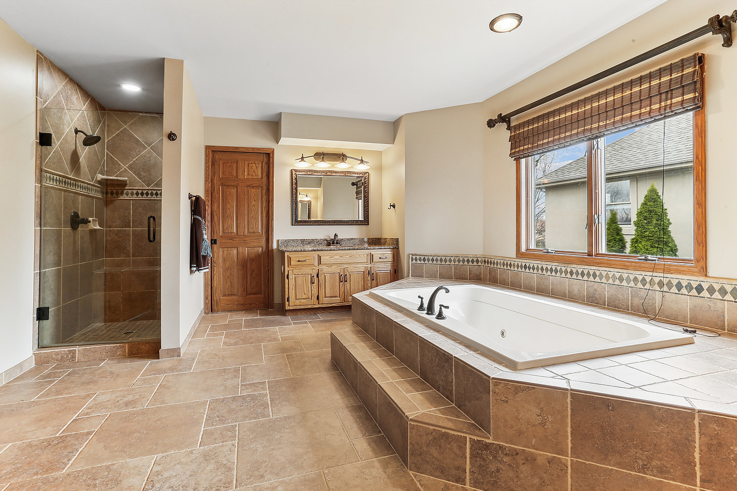 13629 South Kickapoo Trail Homer Glen, IL 60491 - Photo 26 of 28 a bathroom with a tub a sink a mirror and a shower
