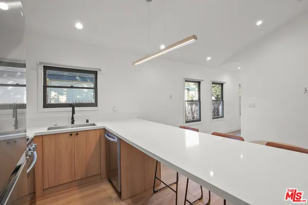 a kitchen with a sink and large window