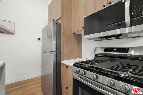 a stove top oven sitting inside of a kitchen