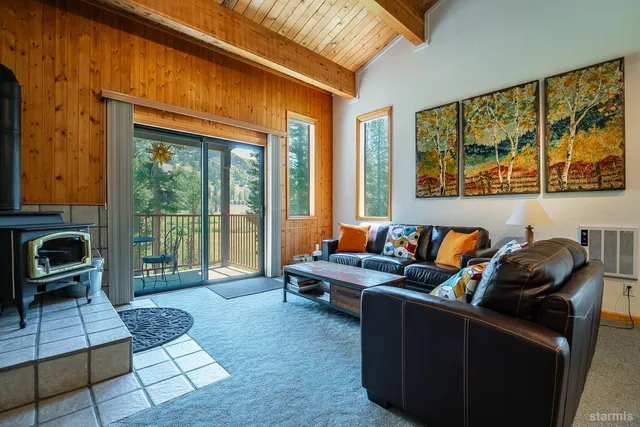 a living room with furniture and a floor to ceiling window