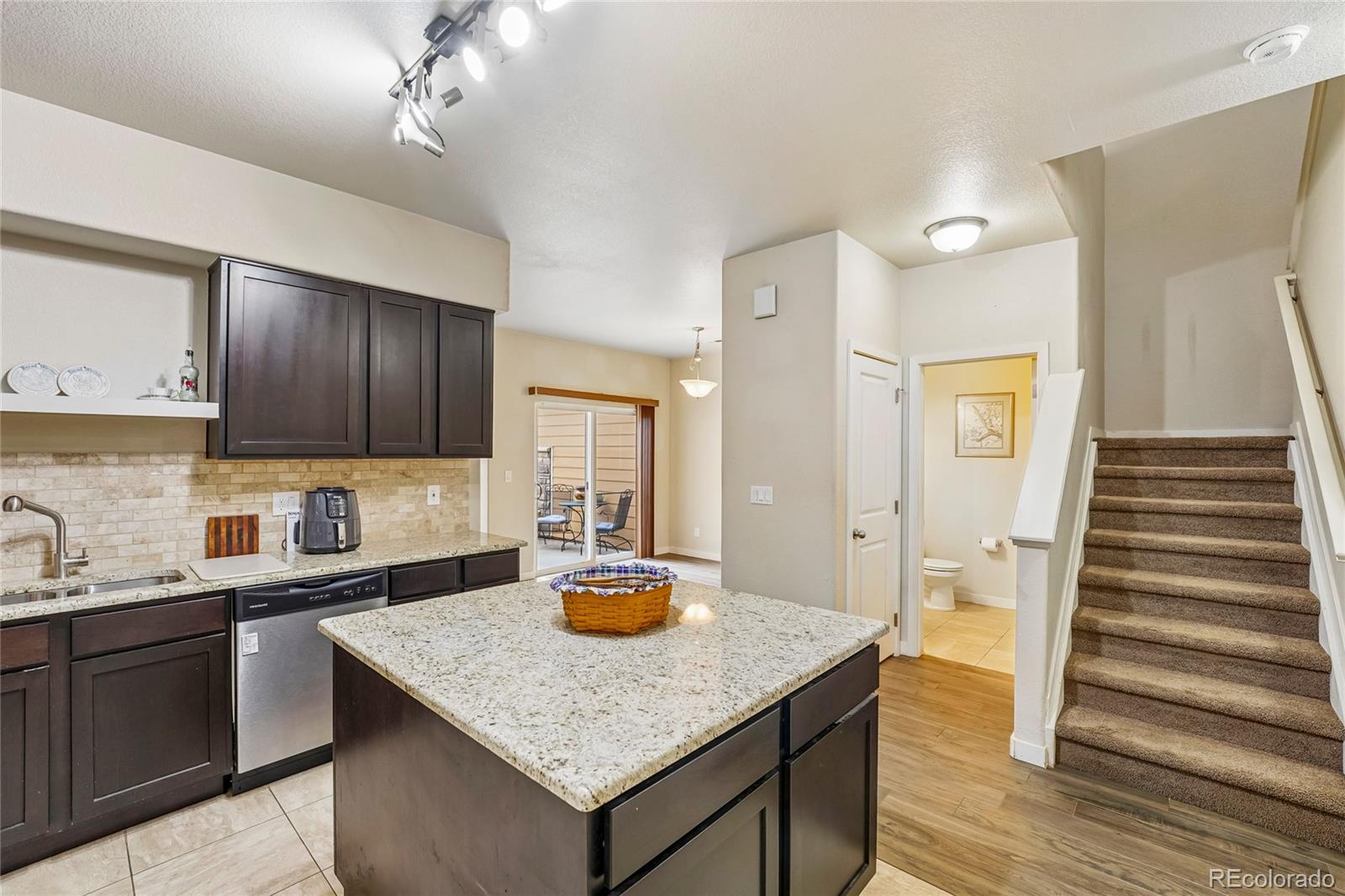 3611 South Perth Circle, Unit 102 Aurora, CO 80013 - Photo 15 of 40 a kitchen with a sink a stove cabinets and wooden floor
