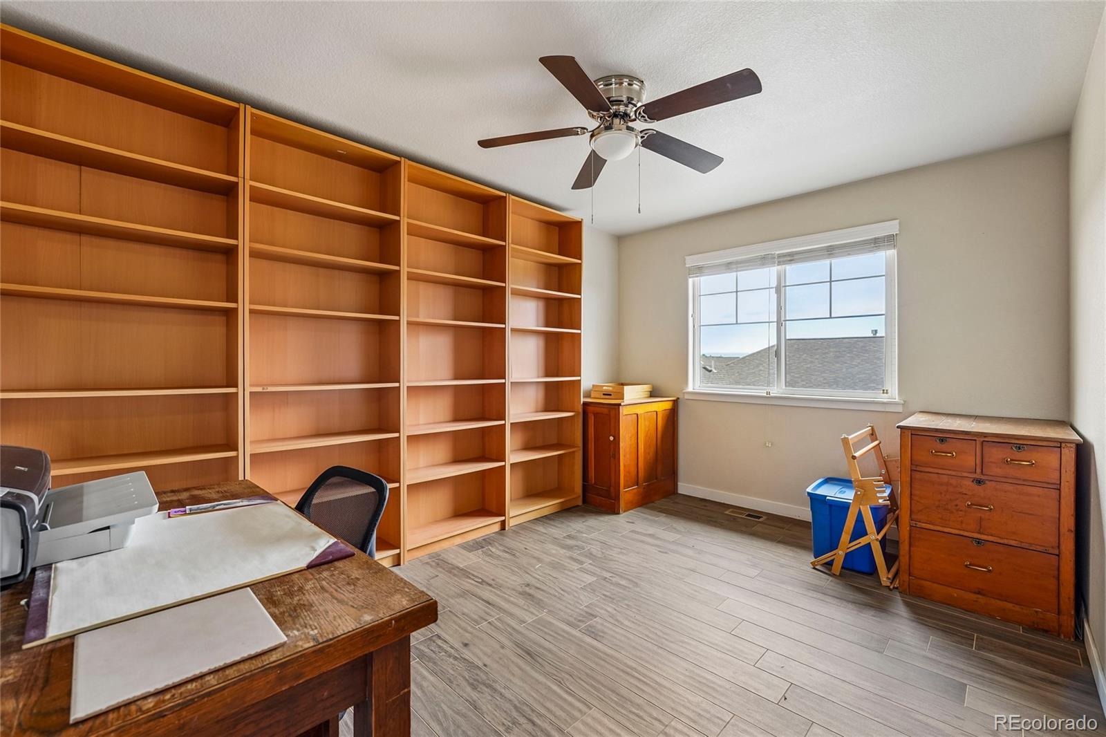 3611 South Perth Circle, Unit 102 Aurora, CO 80013 - Photo 17 of 40 a view of a workspace with furniture and wooden floor