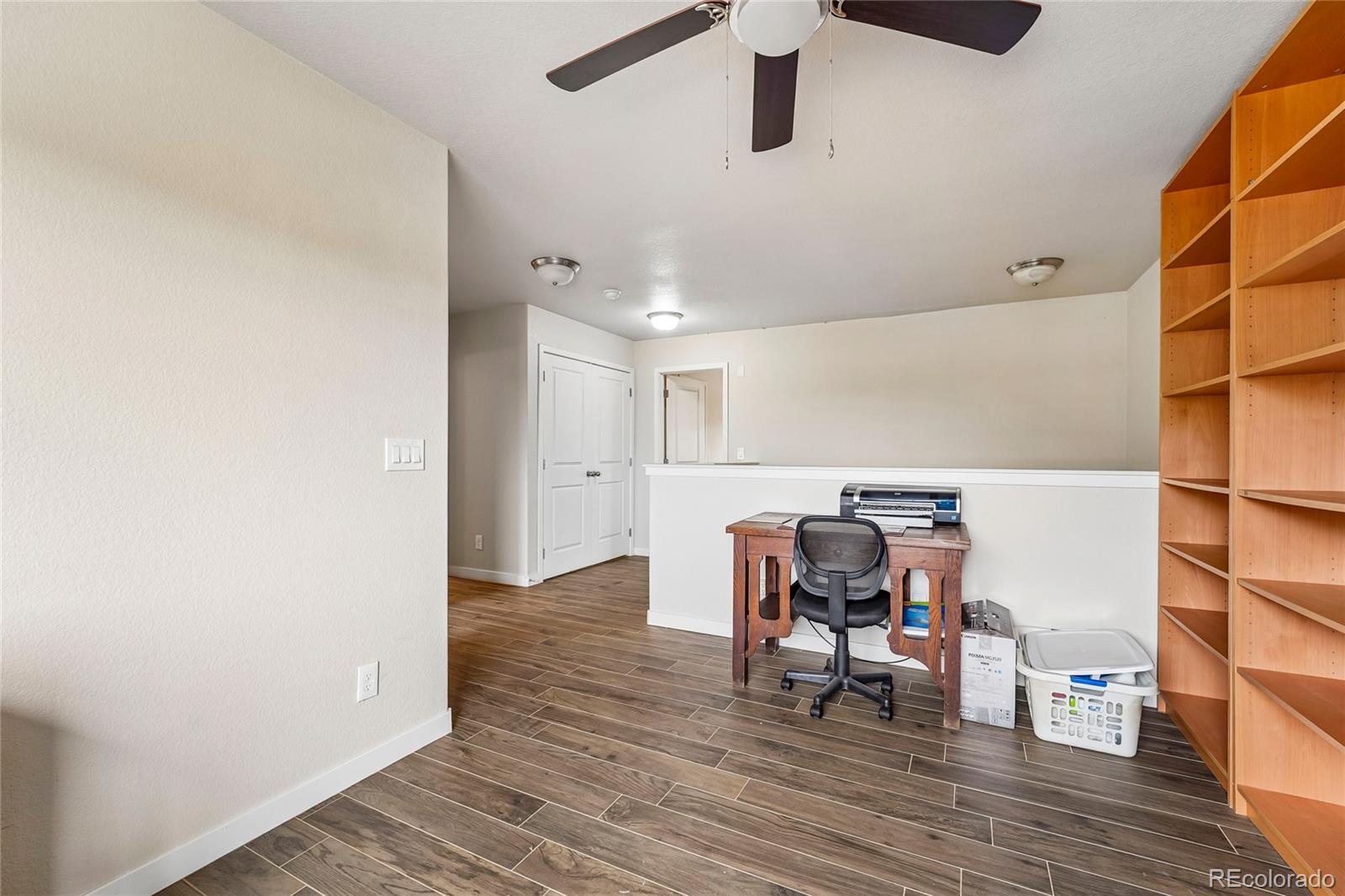 3611 South Perth Circle, Unit 102 Aurora, CO 80013 - Photo 18 of 40 a view of a workspace with furniture and wooden floor