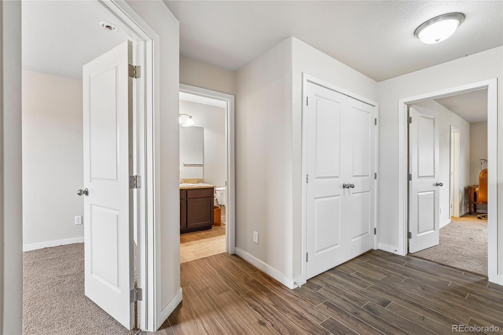 3611 South Perth Circle, Unit 102 Aurora, CO 80013 - Photo 20 of 40 a view of a hallway with wooden floor and closet area