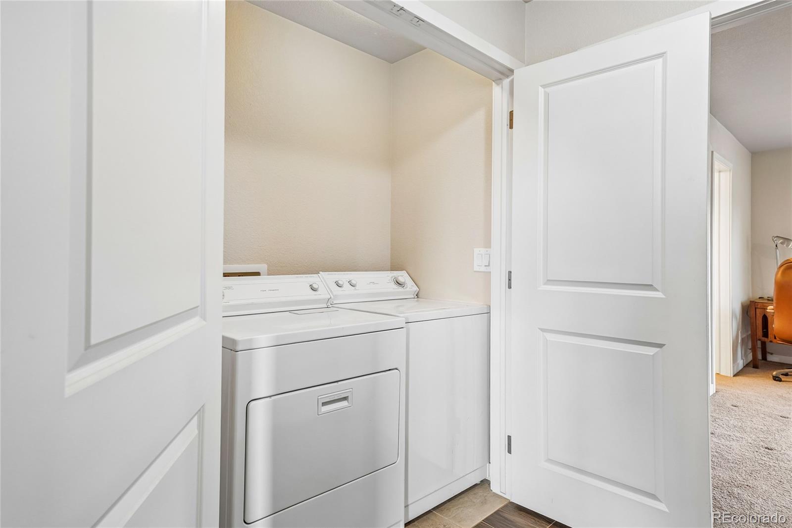 3611 South Perth Circle, Unit 102 Aurora, CO 80013 - Photo 24 of 40 a utility room with dryer and washer