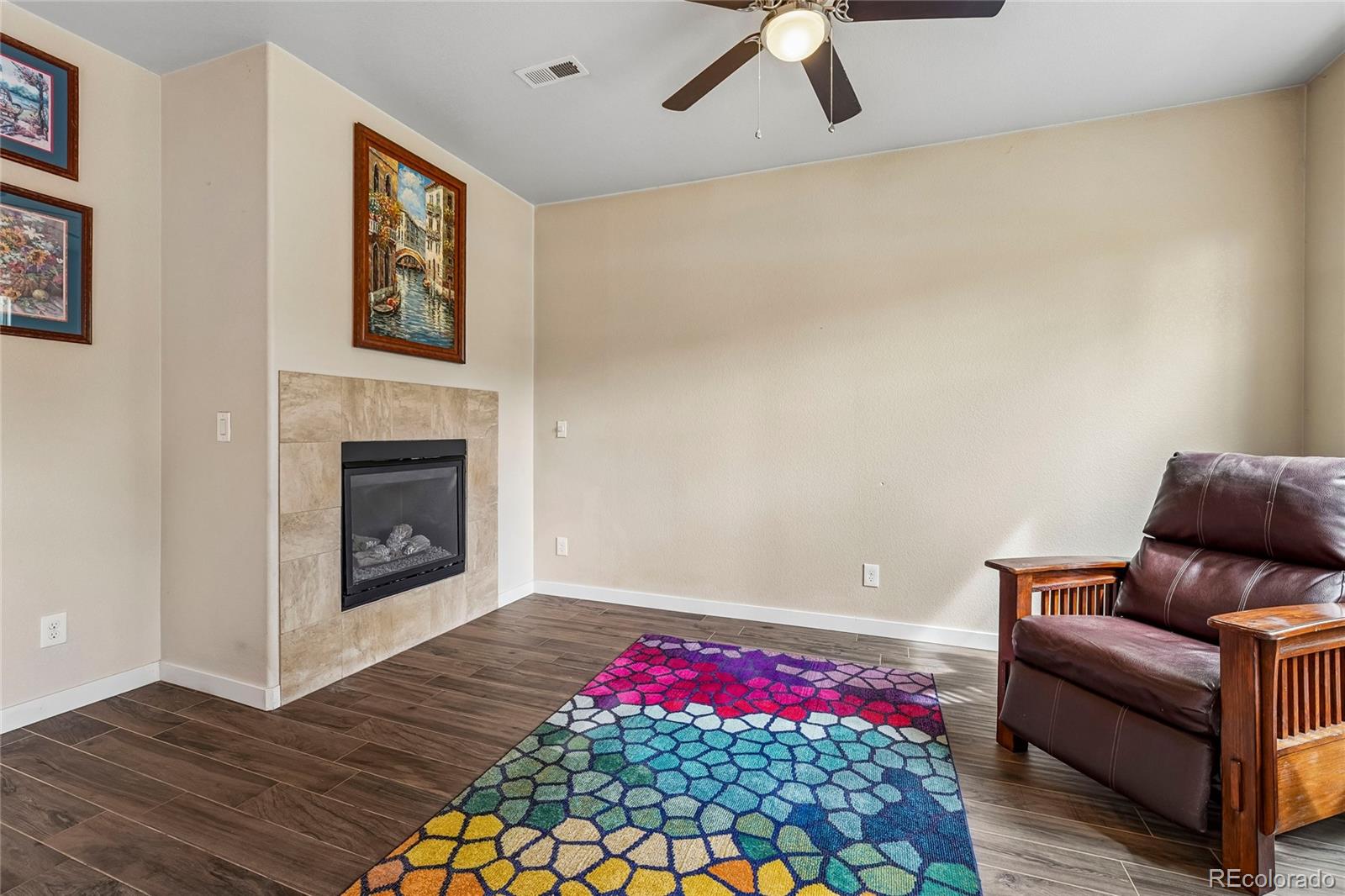 3611 South Perth Circle, Unit 102 Aurora, CO 80013 - Photo 3 of 40 a living room with furniture and a fireplace