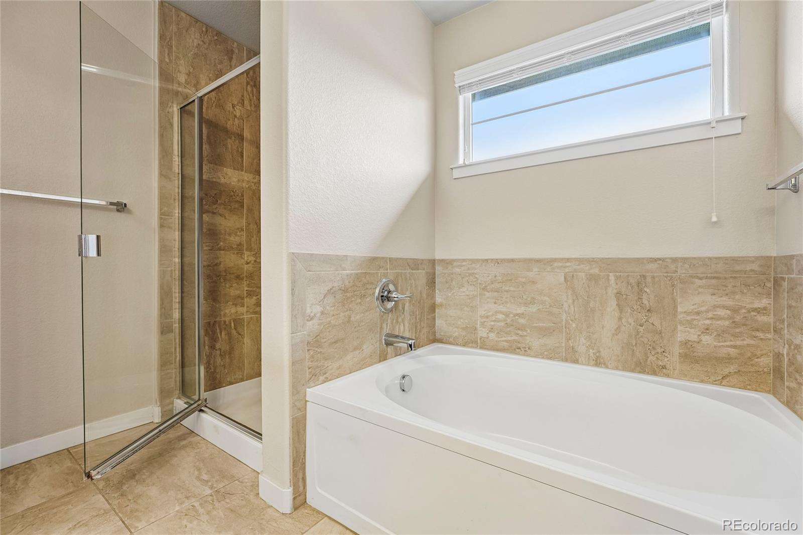 3611 South Perth Circle, Unit 102 Aurora, CO 80013 - Photo 33 of 40 a bathroom with a bathtub and shower