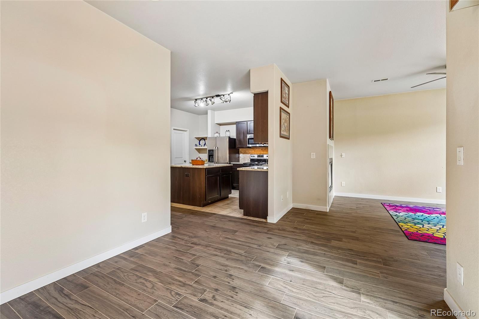 3611 South Perth Circle, Unit 102 Aurora, CO 80013 - Photo 5 of 40 a view of kitchen with wooden floor