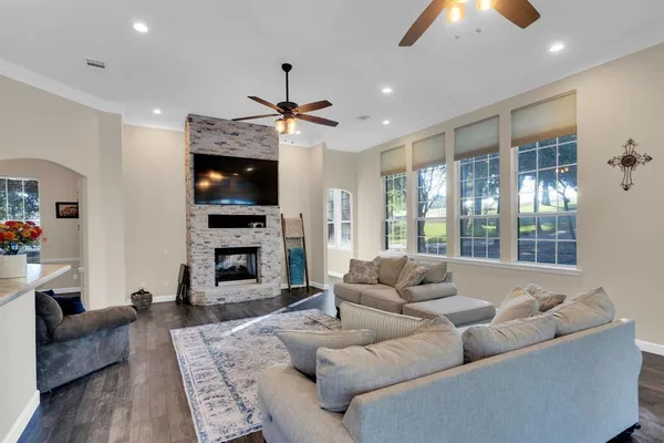 a living room with furniture a fireplace and a flat screen tv