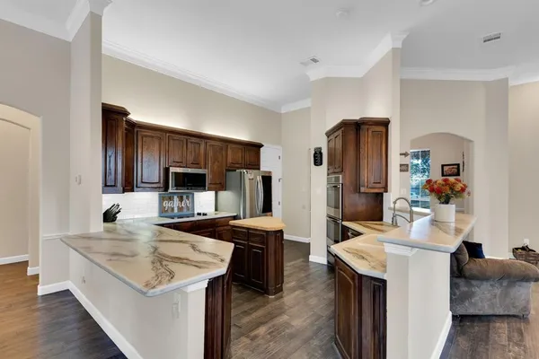 a kitchen with a sink stove and refrigerator